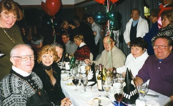Standing left: Donna E.  Seated (left to right): Red , Rosemary A, Alex 	(behind Rosemary),  	Don M (behind balloon string), Jimmy M